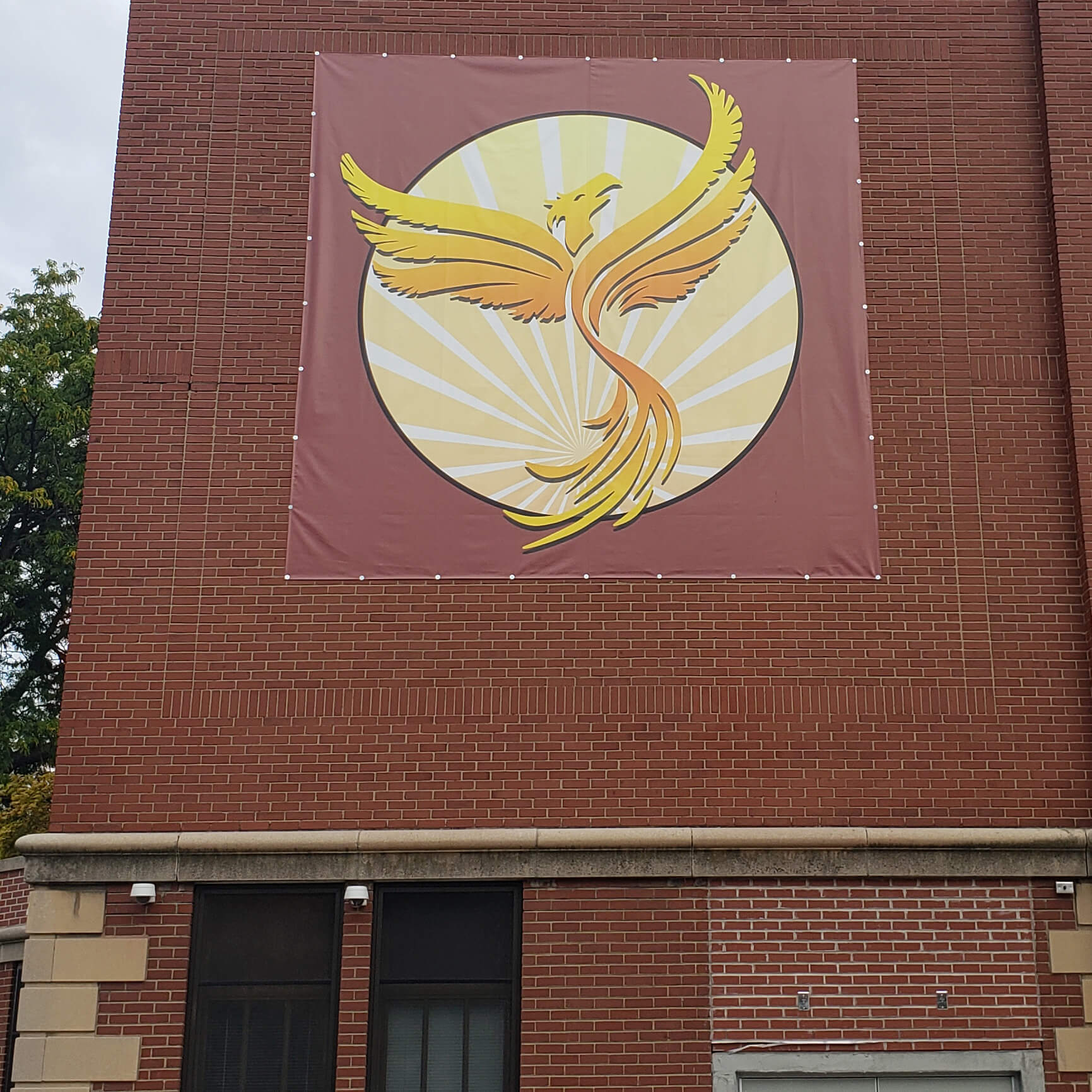 phoenix square custom design printed vinyl banner on an outdoor brick wall